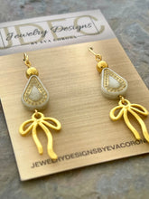 Load image into Gallery viewer, Silver and gold Czech glass teardrop earrings with bow charms
